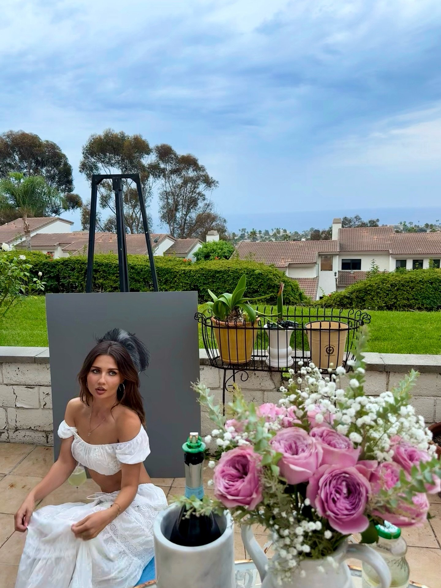 Daría standing beside one of her portrait artworks